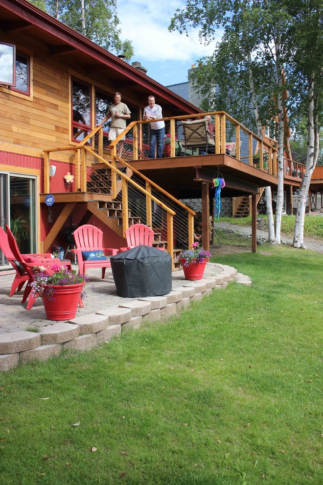 Deck - large rustic backyard deck idea with no cover