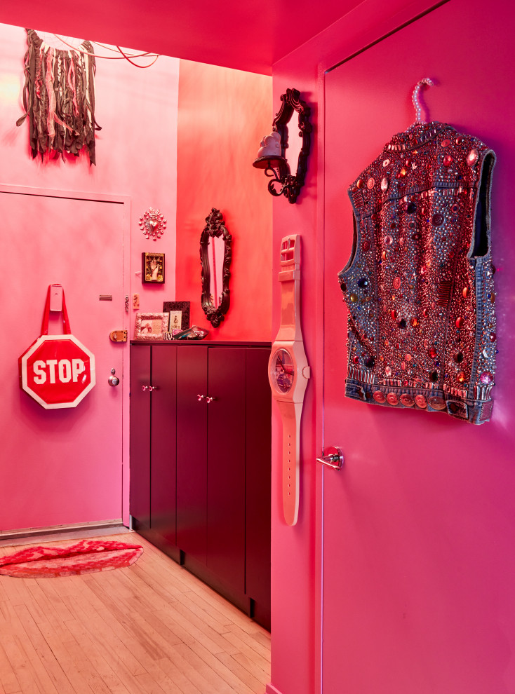Design ideas for a small bohemian hallway in New York with pink walls, light hardwood flooring, a single front door, a purple front door and beige floors.