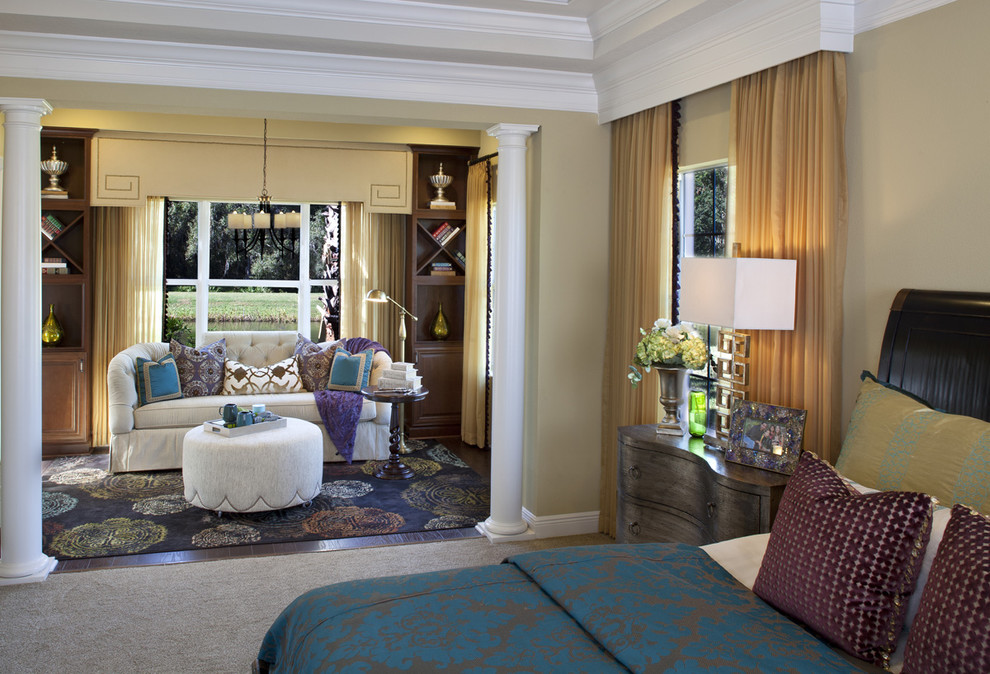 This is an example of a transitional master bedroom in Orlando with beige walls.