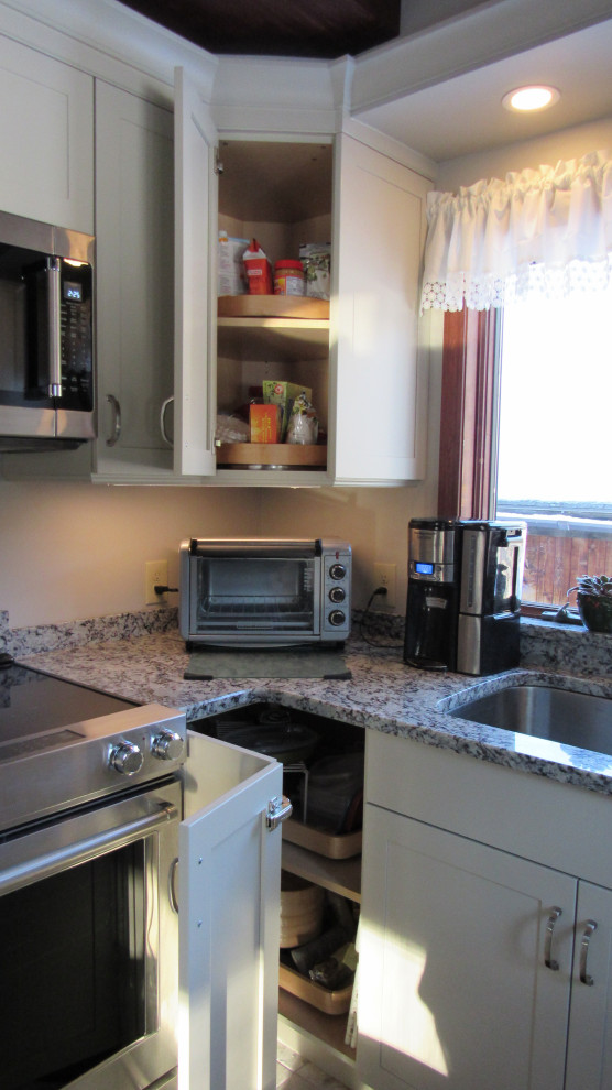 Mid-sized transitional u-shaped eat-in kitchen photo in Boston with an undermount sink, shaker cabinets, beige cabinets, granite countertops, stainless steel appliances, a peninsula and gray countertops
