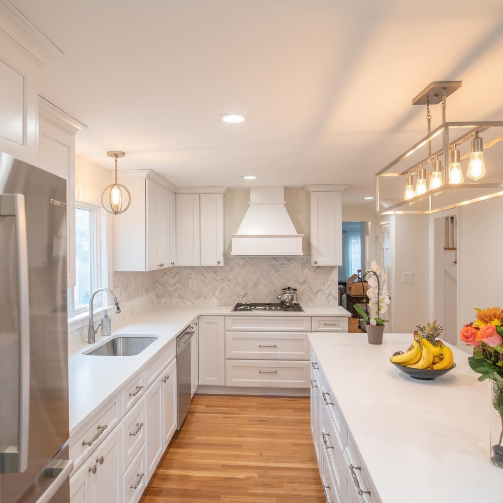Open concept kitchen - mid-sized transitional l-shaped open concept kitchen idea in Providence with recessed-panel cabinets, white cabinets, quartz countertops, an island and white countertops