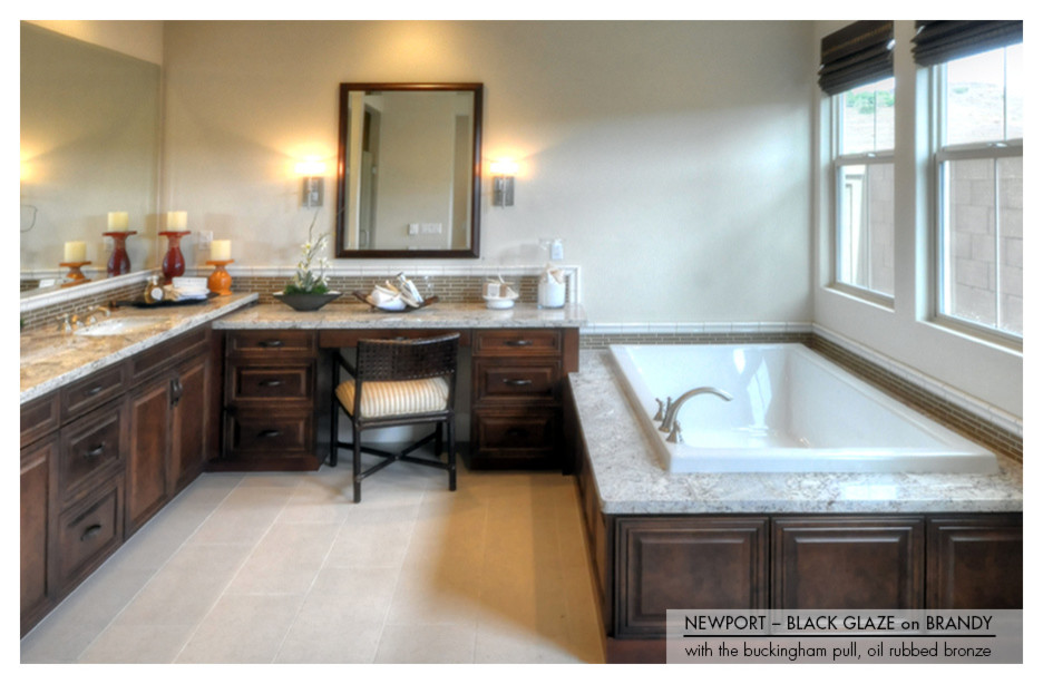 Large traditional master bathroom in Phoenix with an undermount sink, raised-panel cabinets, dark wood cabinets, a double shower, beige tile, porcelain tile, beige walls and travertine floors.