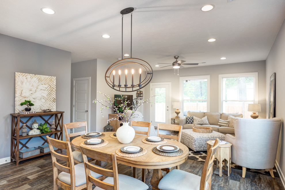 Example of a mid-sized transitional open concept vinyl floor dining room design with gray walls, no fireplace and a tv stand