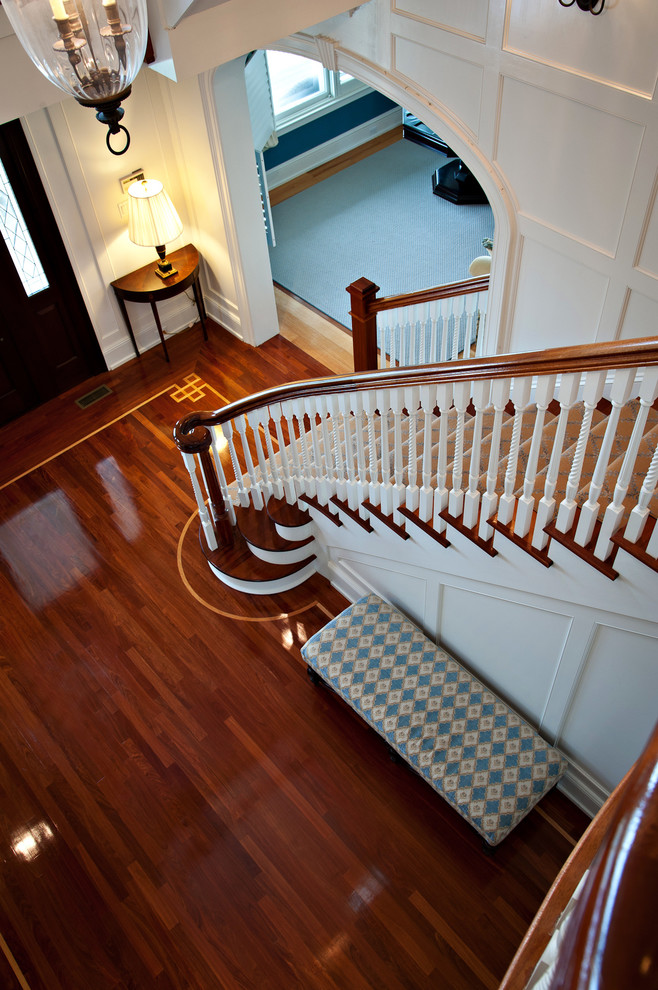 Photo of a traditional carpeted staircase in New York with wood risers.