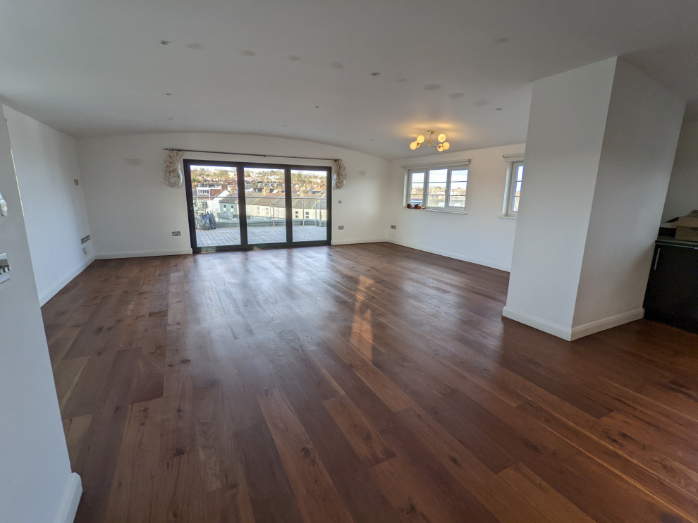 Inspiration for a modern living room in London with medium hardwood floors.