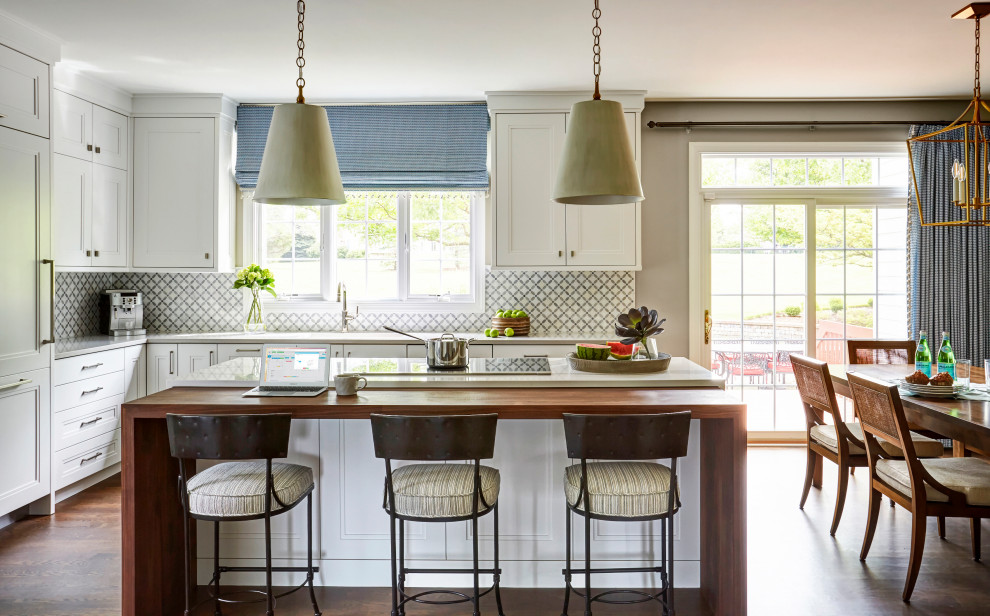 Example of a large transitional l-shaped dark wood floor and brown floor eat-in kitchen design in Chicago with quartzite countertops, stone tile backsplash and two islands