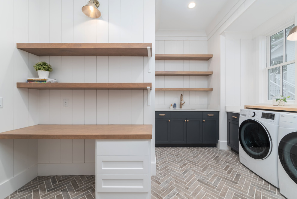 This is an example of a beach style laundry room in Other with shiplap splashback and planked wall panelling.