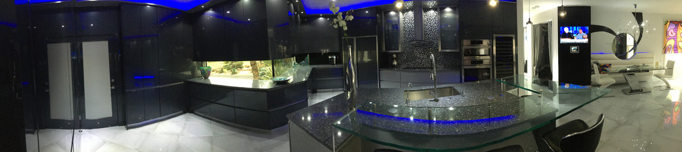 Inspiration for a large modern u-shaped porcelain tile eat-in kitchen remodel with an undermount sink, flat-panel cabinets, gray cabinets, quartz countertops, metallic backsplash, glass sheet backsplash, stainless steel appliances and an island