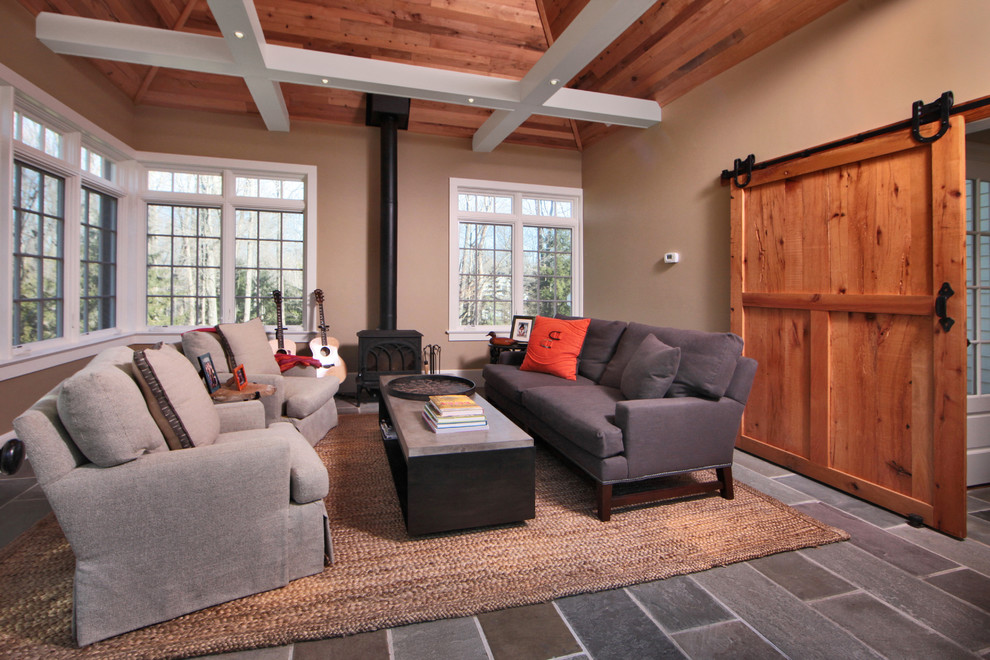 Traditional enclosed living room in Other with a music area, beige walls and a wood stove.