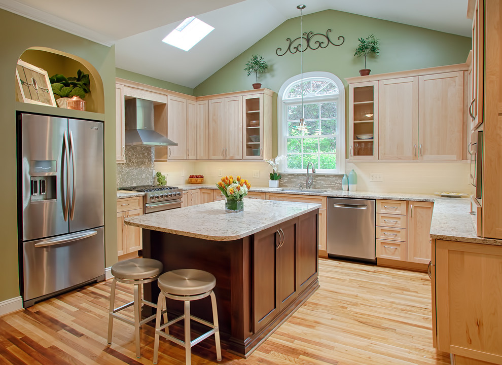 Inspiration for a mid-sized transitional u-shaped light wood floor eat-in kitchen remodel in Raleigh with an undermount sink, shaker cabinets, light wood cabinets, quartz countertops, multicolored backsplash, glass tile backsplash, stainless steel appliances, green walls and an island