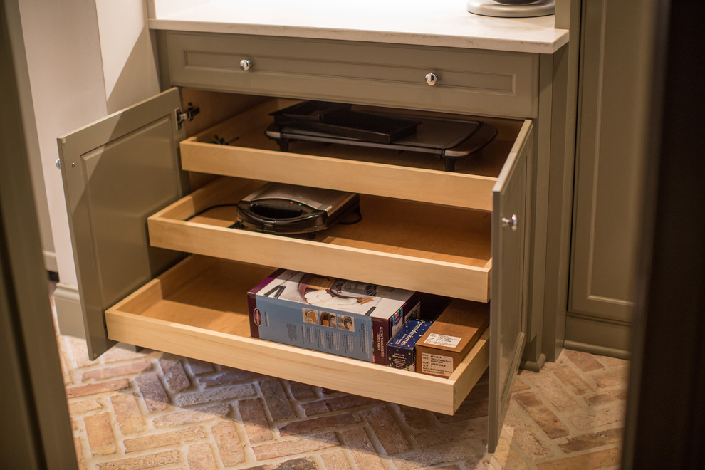 Inspiration for a large transitional l-shaped brick floor and multicolored floor eat-in kitchen remodel in Birmingham with a farmhouse sink, flat-panel cabinets, gray cabinets, quartzite countertops, gray backsplash, subway tile backsplash, stainless steel appliances and an island