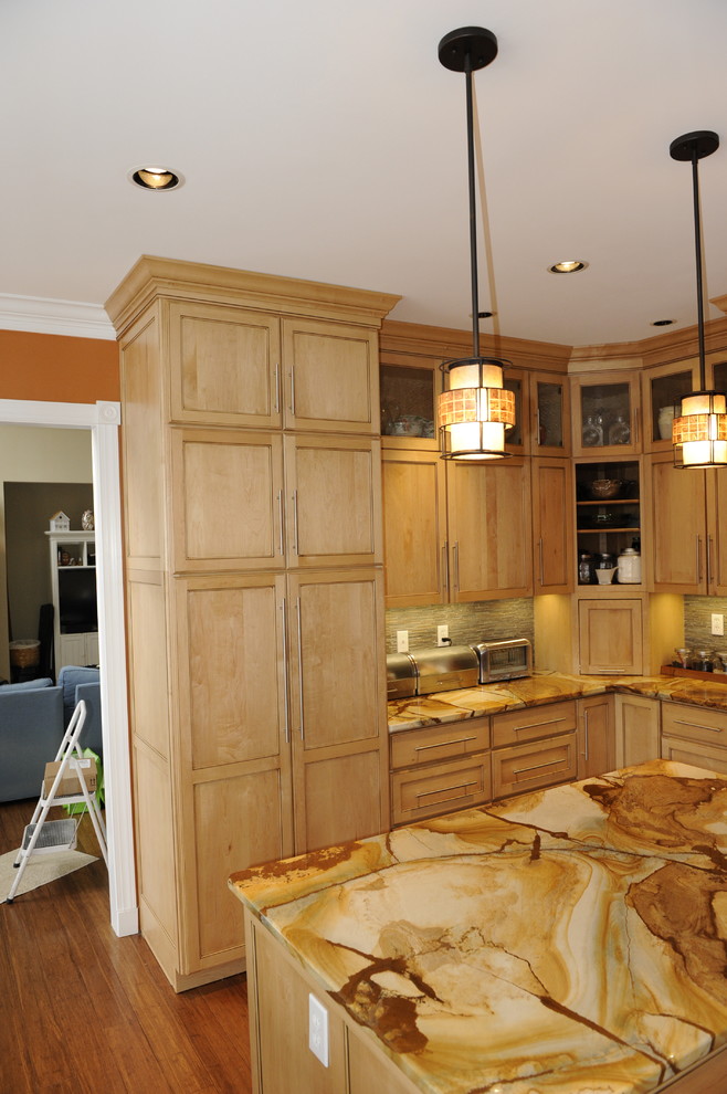 Mid-sized transitional u-shaped light wood floor eat-in kitchen photo in Baltimore with a farmhouse sink, beaded inset cabinets, light wood cabinets, onyx countertops, stainless steel appliances and an island