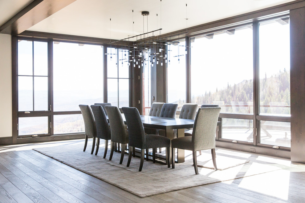 This is an example of a transitional open plan dining in Salt Lake City with white walls and light hardwood floors.