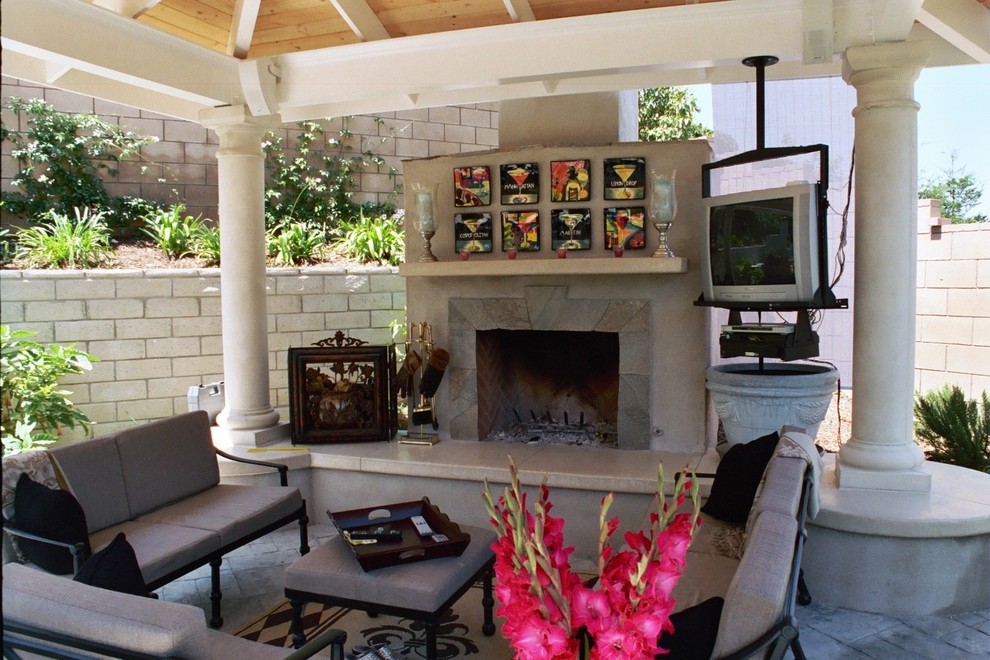 Mid-sized contemporary backyard patio in Los Angeles with a fire feature, natural stone pavers and a gazebo/cabana.