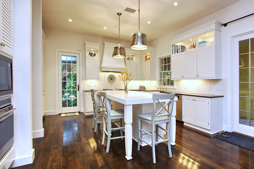 Inspiration for a transitional kitchen in Tampa with louvered cabinets and white cabinets.