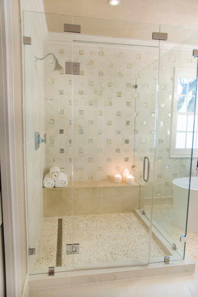 Mid-sized contemporary master bathroom in Austin with recessed-panel cabinets, beige cabinets, a freestanding tub, a corner shower, beige tile, pebble tile, beige walls, pebble tile floors and a vessel sink.