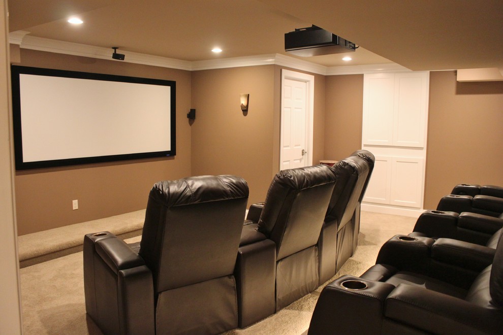 Inspiration for a mid-sized traditional enclosed home theatre in Philadelphia with brown walls, carpet, a projector screen and beige floor.