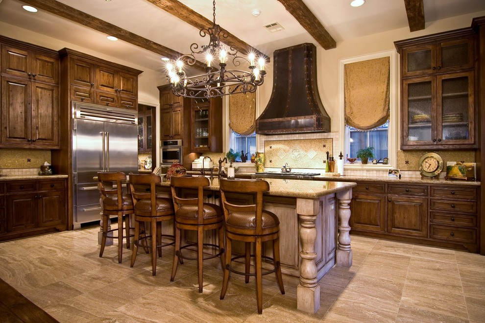 Photo of a mediterranean kitchen in Houston with raised-panel cabinets, stainless steel appliances, dark wood cabinets and multi-coloured splashback.