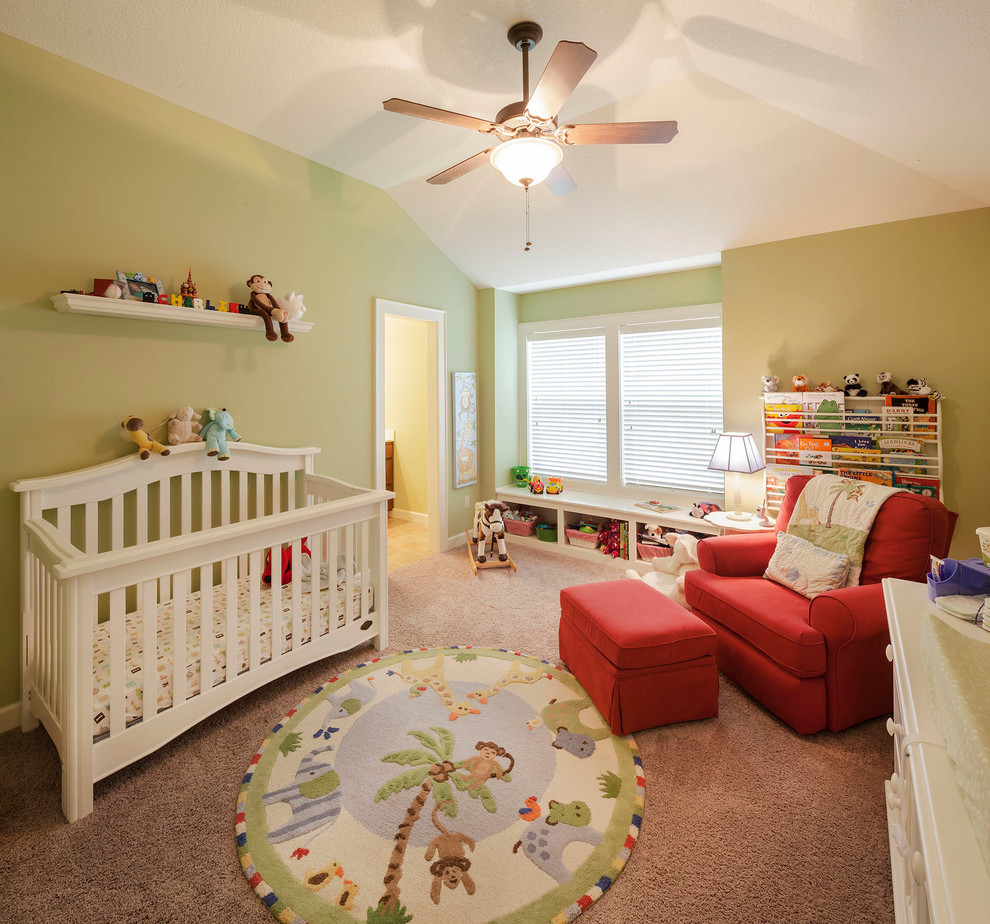 This is an example of a mid-sized traditional gender-neutral nursery in Kansas City with green walls and carpet.