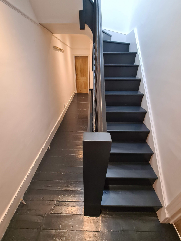 Inspiration for an expansive traditional hallway in London with white walls, painted wood floors, black floor and recessed.