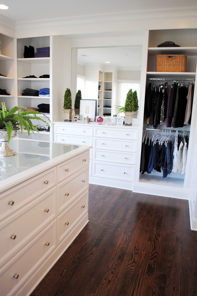 Inspiration for a traditional women's dressing room in Raleigh with recessed-panel cabinets, white cabinets and dark hardwood floors.