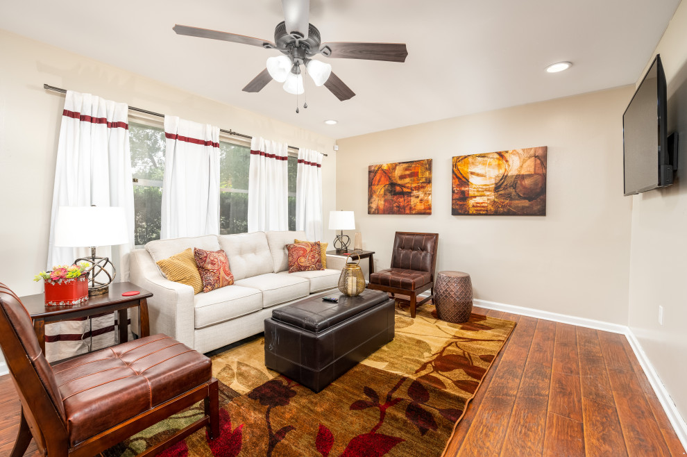 Mid-sized elegant enclosed vinyl floor and brown floor living room photo in New Orleans with beige walls