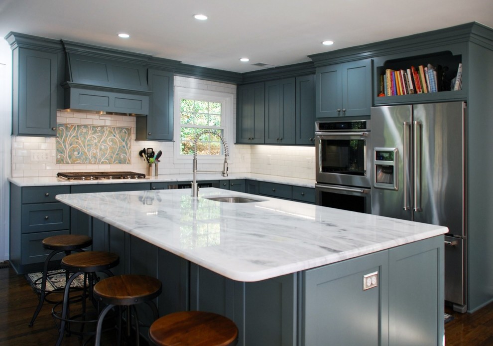 Large transitional l-shaped dark wood floor and brown floor enclosed kitchen photo in DC Metro with an undermount sink, shaker cabinets, blue cabinets, marble countertops, white backsplash, subway tile backsplash, stainless steel appliances and an island
