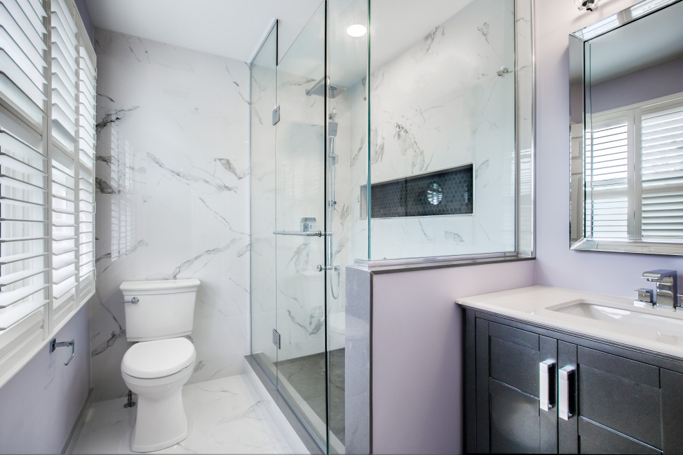 Design ideas for a mid-sized contemporary master bathroom in Toronto with blue cabinets, an open shower, a two-piece toilet, yellow tile, porcelain tile, purple walls, porcelain floors, an undermount sink, engineered quartz benchtops, a hinged shower door, white benchtops, a niche, a single vanity and a freestanding vanity.