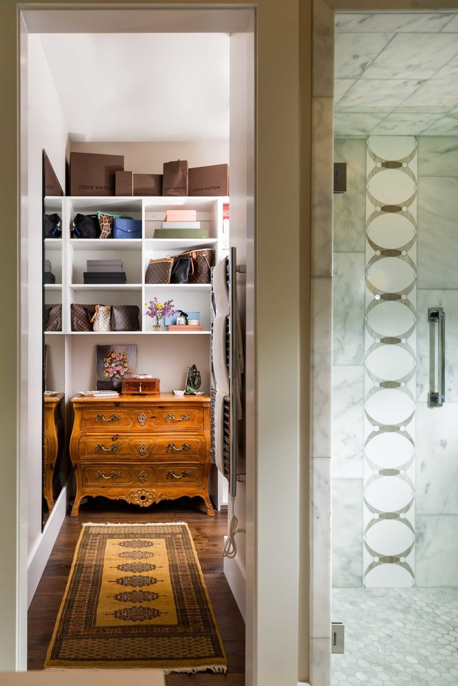 Design ideas for a mid-sized gender-neutral walk-in wardrobe in Other with medium hardwood floors.