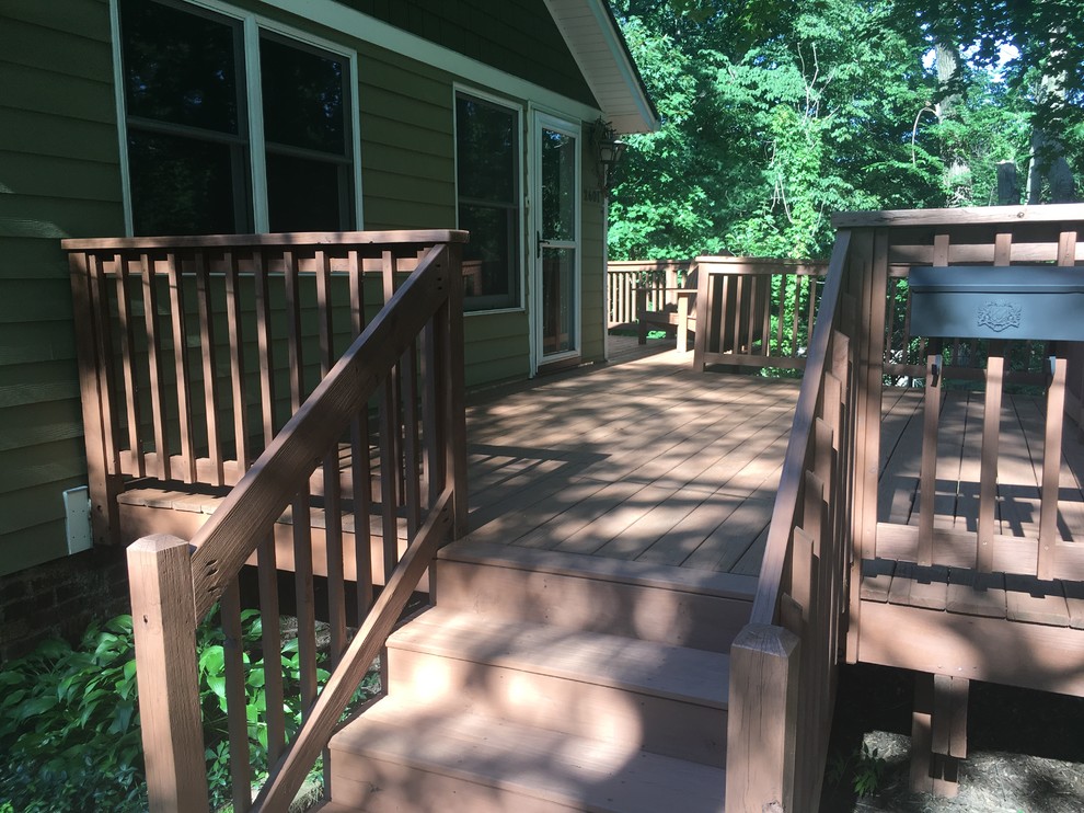 Example of a mid-sized mountain style backyard deck design with no cover