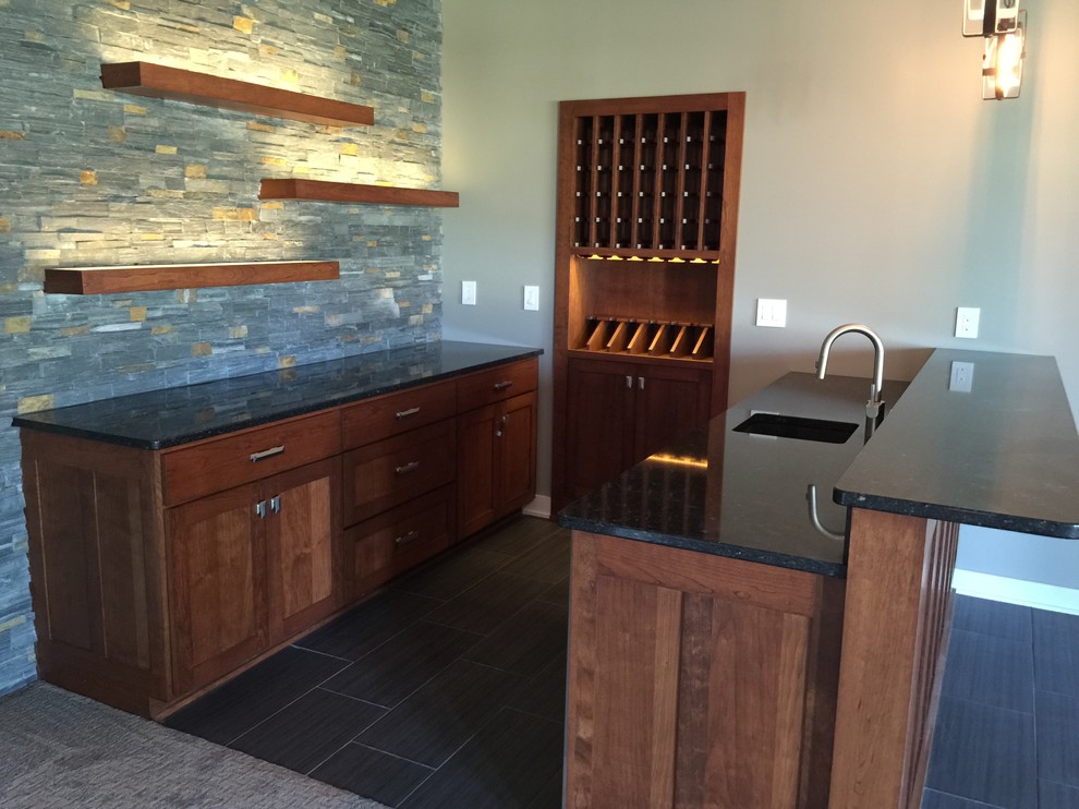 Mid-sized transitional wine cellar in Omaha with porcelain floors, display racks and black floor.