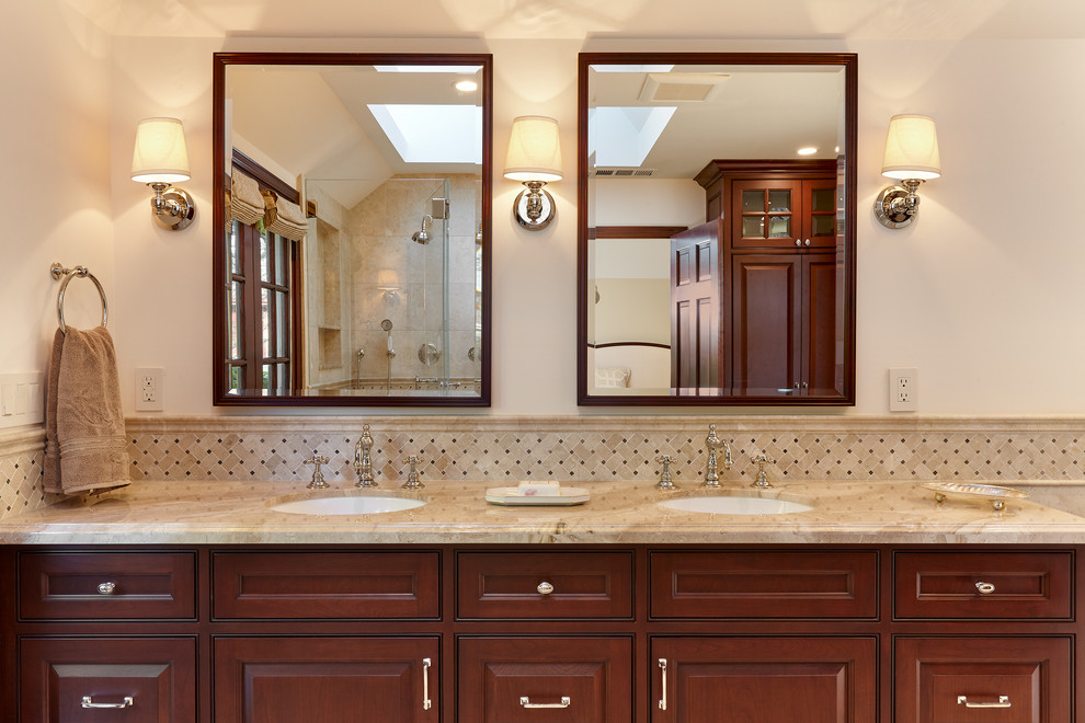 Inspiration for a large traditional master bathroom in San Francisco with beaded inset cabinets, brown cabinets, an alcove shower, a two-piece toilet, gray tile, marble, marble floors, an undermount sink, marble benchtops, a claw-foot tub and beige walls.