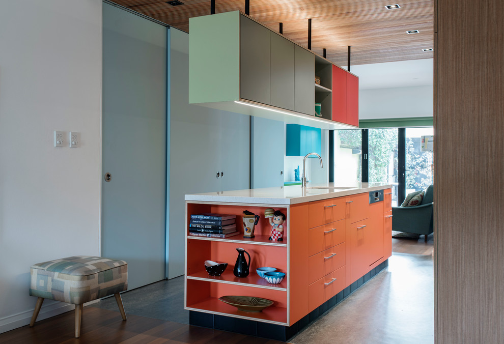 This is an example of a mid-sized contemporary galley kitchen pantry in Sydney with a single-bowl sink, flat-panel cabinets, orange cabinets, terrazzo benchtops, stainless steel appliances, linoleum floors and with island.