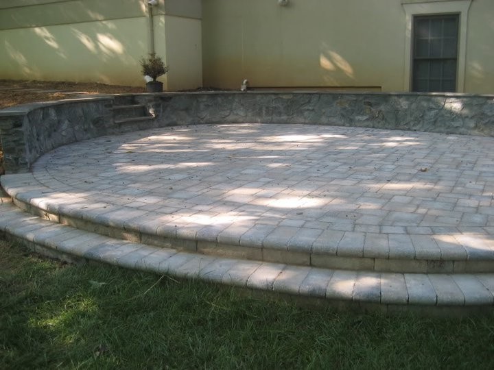 Photo of a mid-sized traditional backyard patio in DC Metro with no cover and brick pavers.