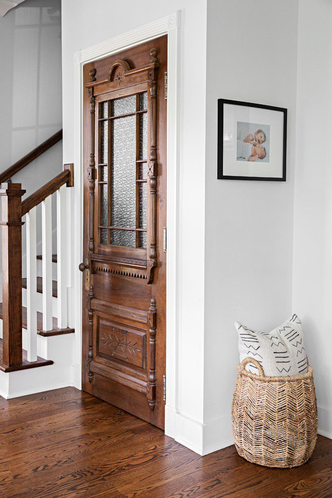 Design ideas for a country foyer in Nashville with white walls, dark hardwood floors and brown floor.
