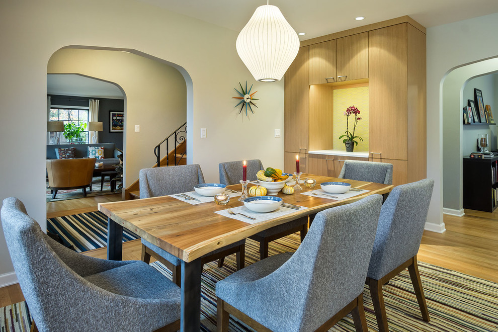 Photo of a contemporary kitchen/dining combo in Portland with beige walls and medium hardwood floors.