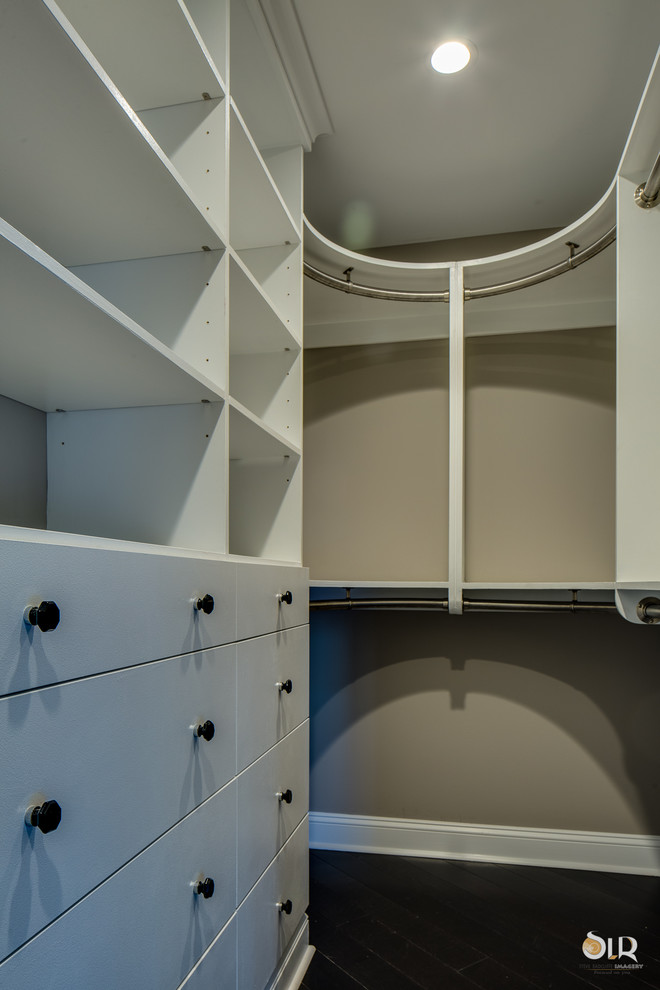 Walk-in closet - transitional gender-neutral dark wood floor and brown floor walk-in closet idea with open cabinets and white cabinets