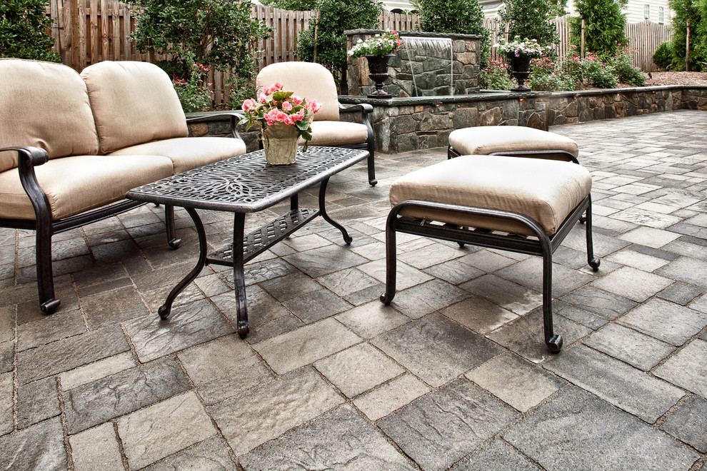 Patio fountain - large modern backyard concrete paver patio fountain idea in DC Metro