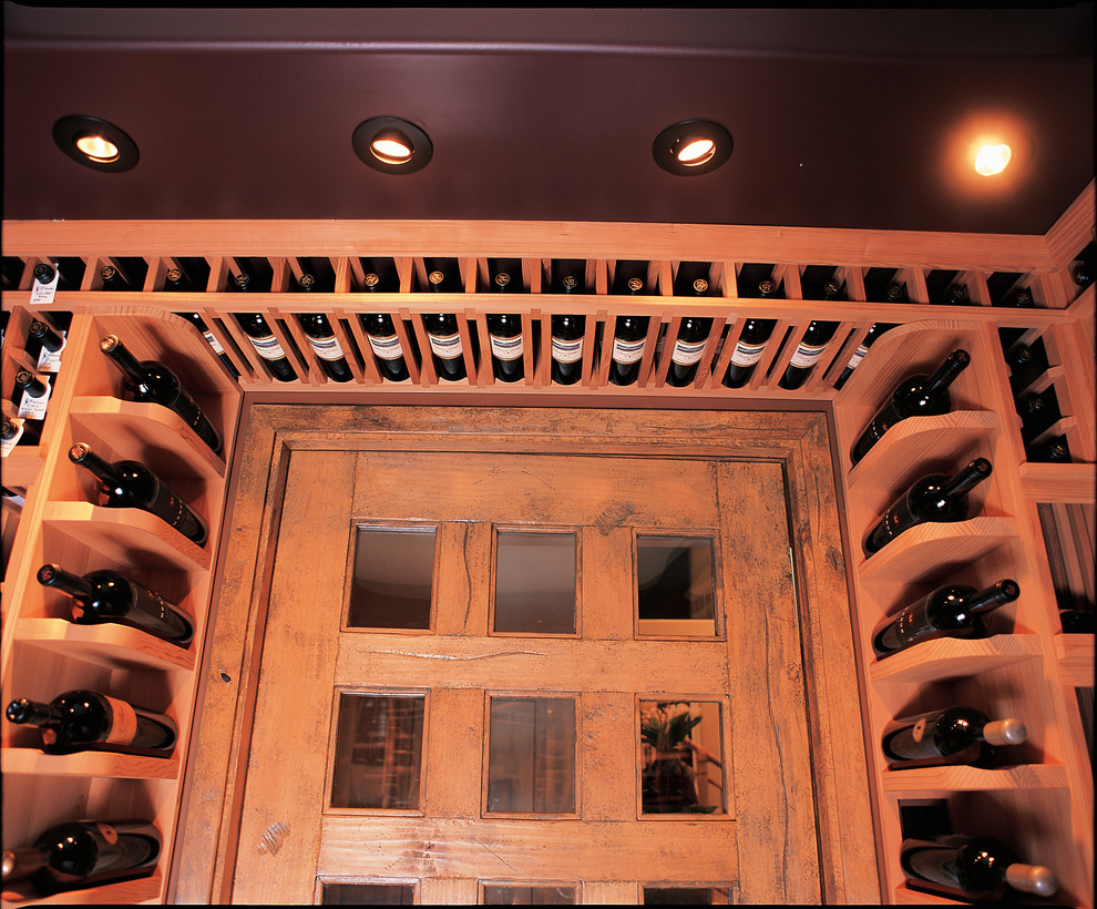 Large country wine cellar in San Diego with marble floors and storage racks.