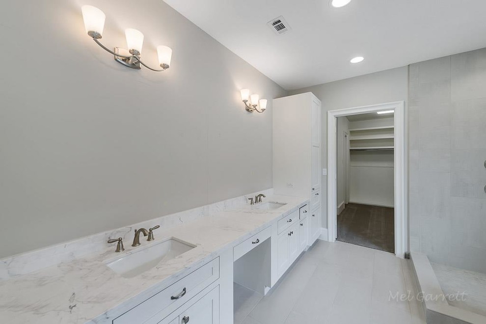 Inspiration for a mid-sized contemporary master bathroom in Houston with shaker cabinets, white cabinets, a hot tub, a corner shower, a two-piece toilet, gray tile, stone tile, grey walls, limestone floors, an undermount sink, granite benchtops, grey floor, an open shower and white benchtops.