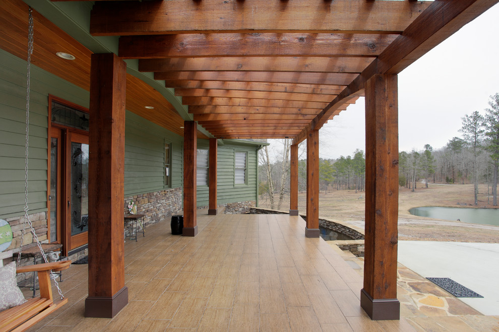 Mid-sized traditional verandah in Birmingham with natural stone pavers and a pergola.