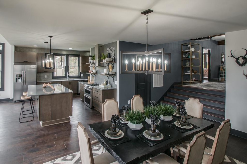 Large contemporary l-shaped eat-in kitchen in Nashville with an undermount sink, flat-panel cabinets, grey cabinets, quartz benchtops, metallic splashback, stainless steel appliances, porcelain floors, with island, brown floor and grey benchtop.