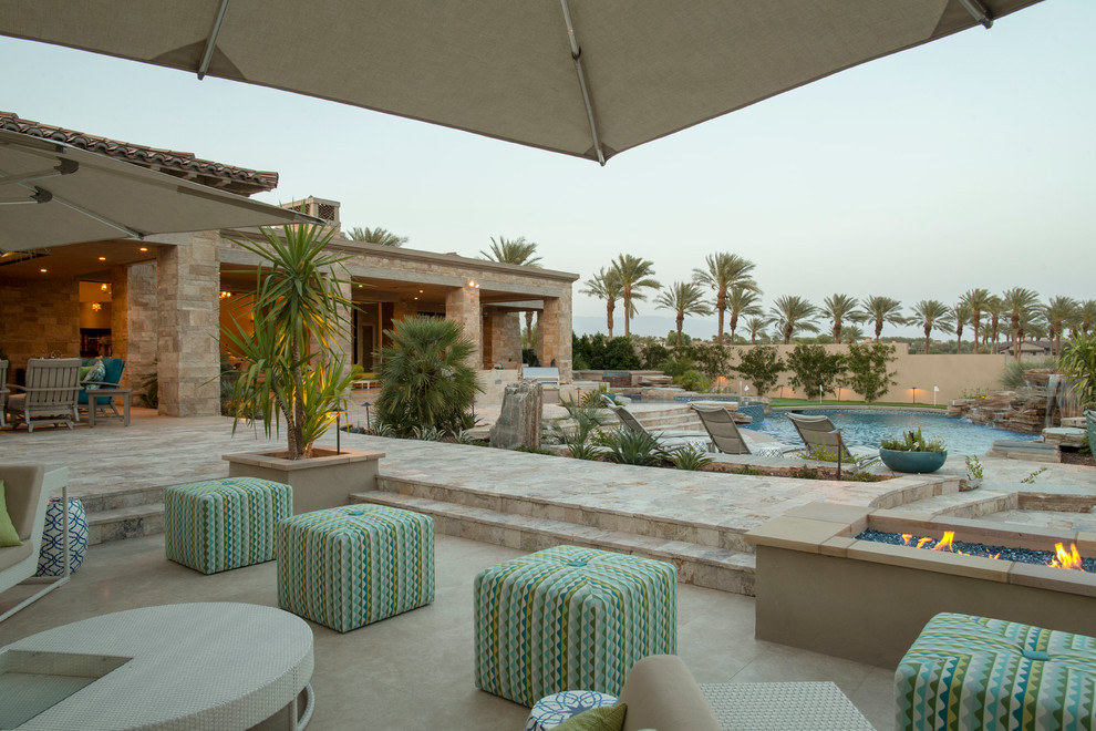 Mid-sized transitional backyard concrete paver and round natural pool fountain photo