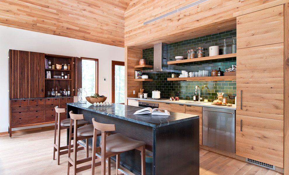 Inspiration for a country single-wall kitchen in New York with an undermount sink, flat-panel cabinets, light wood cabinets, soapstone benchtops, green splashback, subway tile splashback, stainless steel appliances and with island.