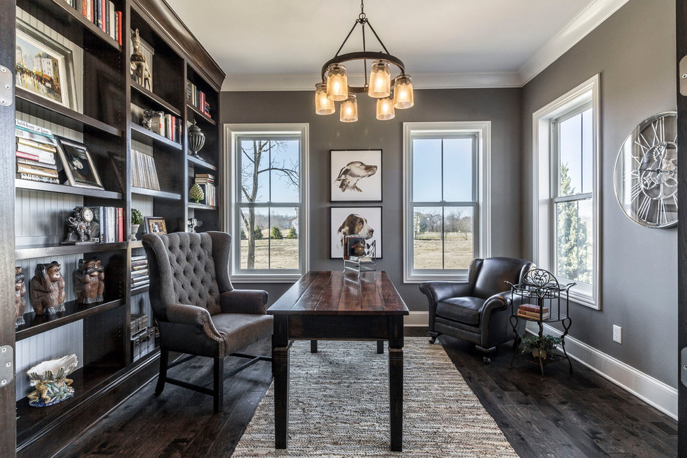 Photo of a large transitional home office in Columbus with grey walls, medium hardwood floors, no fireplace, a freestanding desk and brown floor.