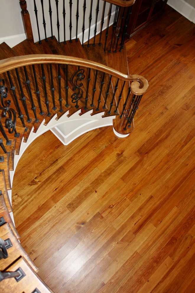 Design ideas for a traditional wood curved staircase in Other with wood risers.