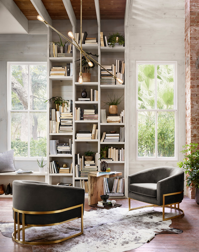 Inspiration for a country home office in Austin with a library, grey walls and brown floor.