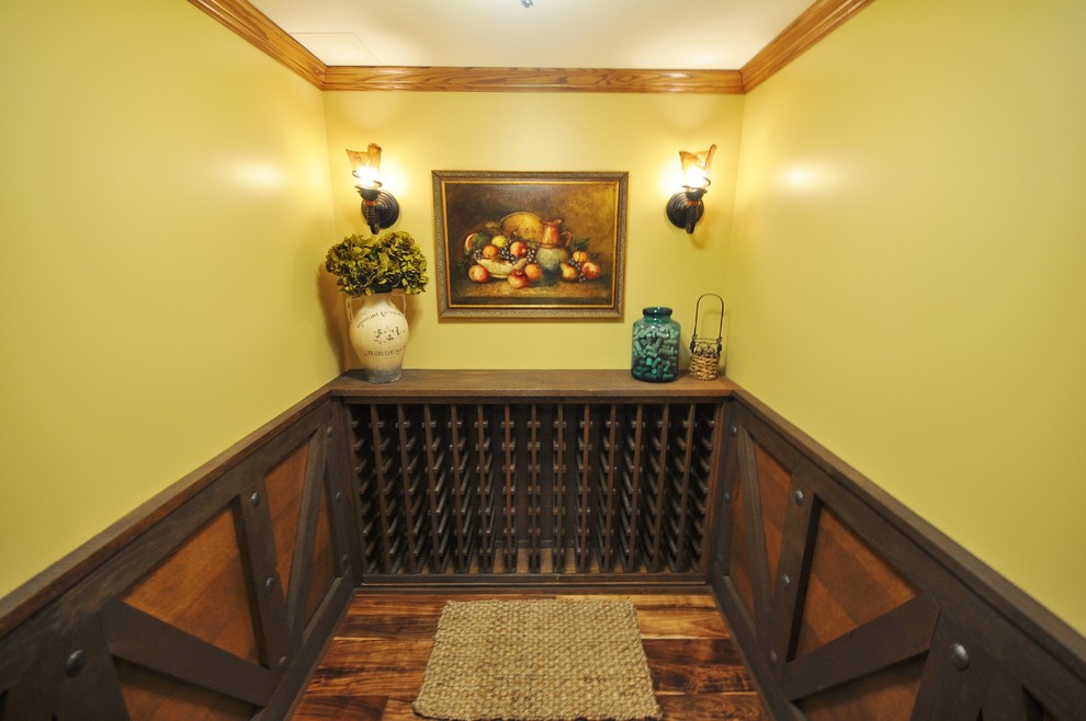 This is an example of a mid-sized country wine cellar in Other with medium hardwood floors and storage racks.