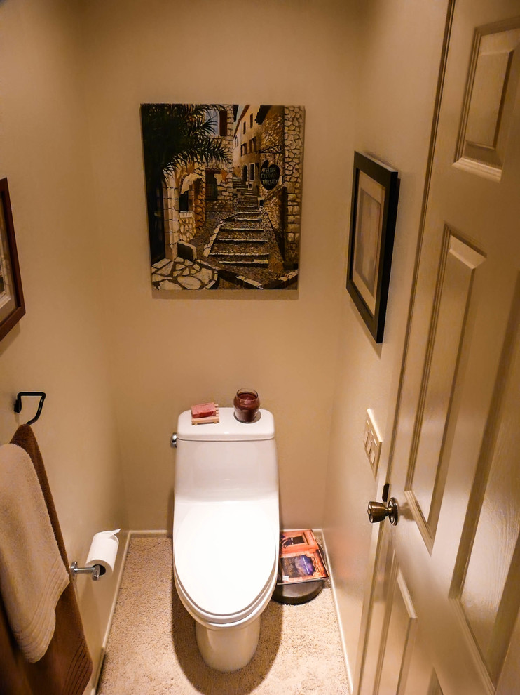 This is an example of a mid-sized transitional powder room in San Diego with flat-panel cabinets, medium wood cabinets, a one-piece toilet, white walls, an undermount sink and granite benchtops.