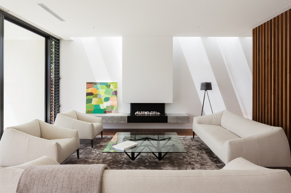 This is an example of a mid-sized modern formal open concept living room in Sydney with white walls, medium hardwood floors, a plaster fireplace surround and a ribbon fireplace.